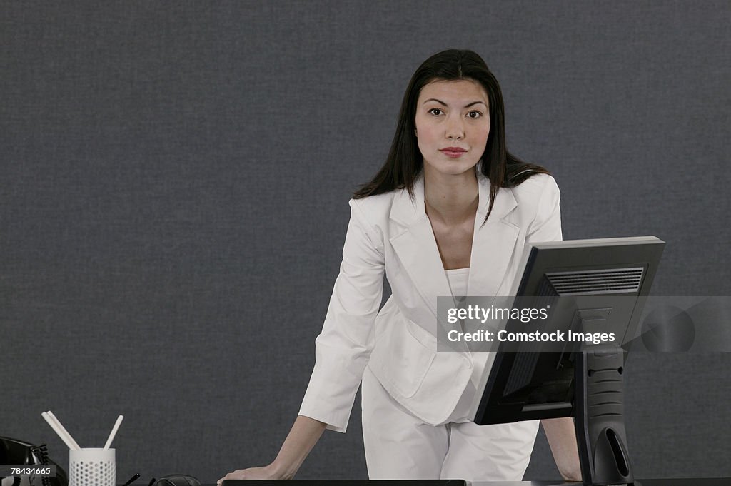 Businesswoman standing at desk