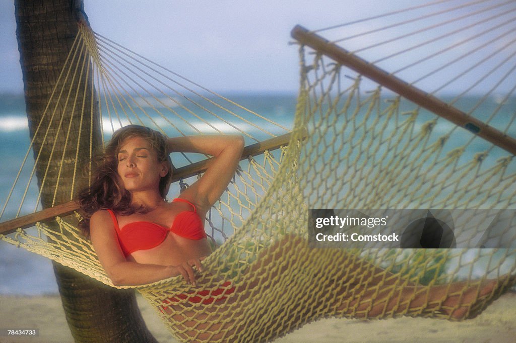 Woman reclining in hammock