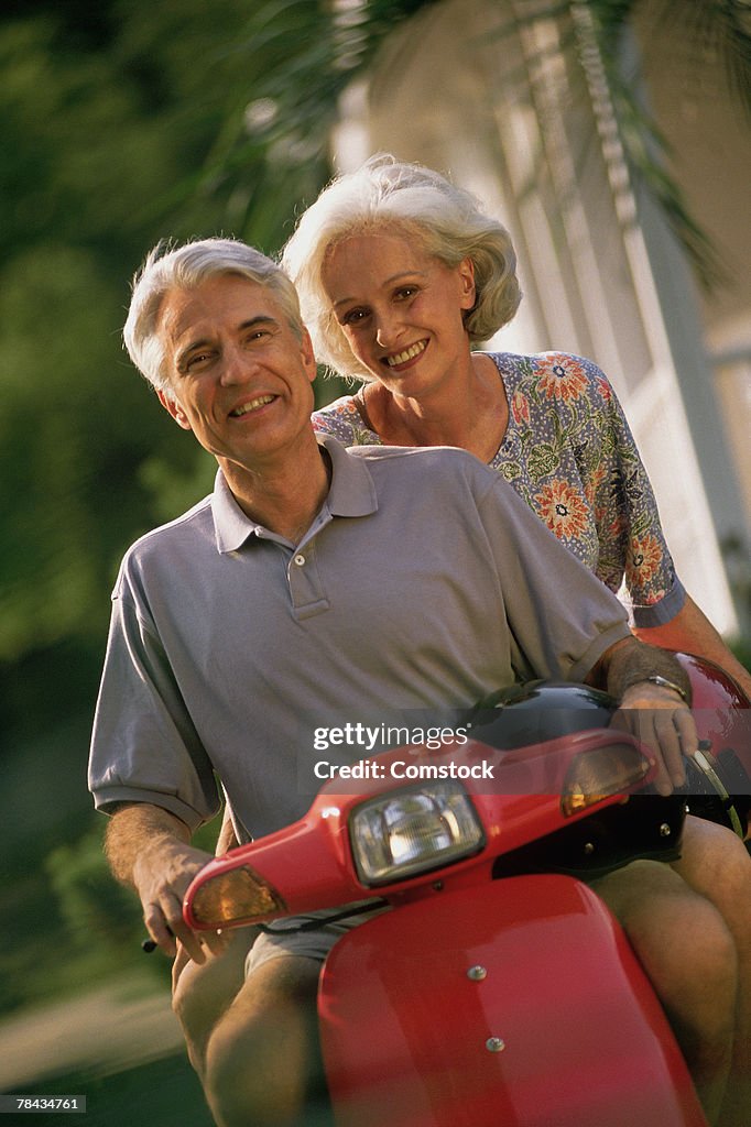 Mature couple on scooter