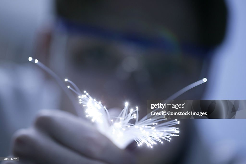 Person holding fiber optics