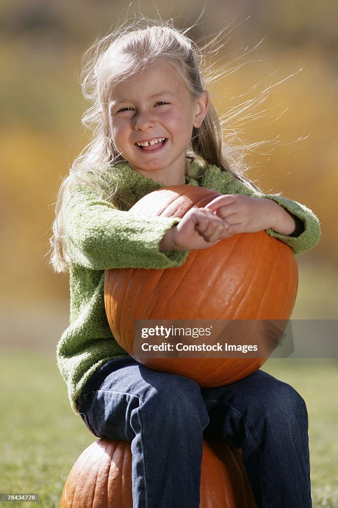 Girl holding a pumpkin