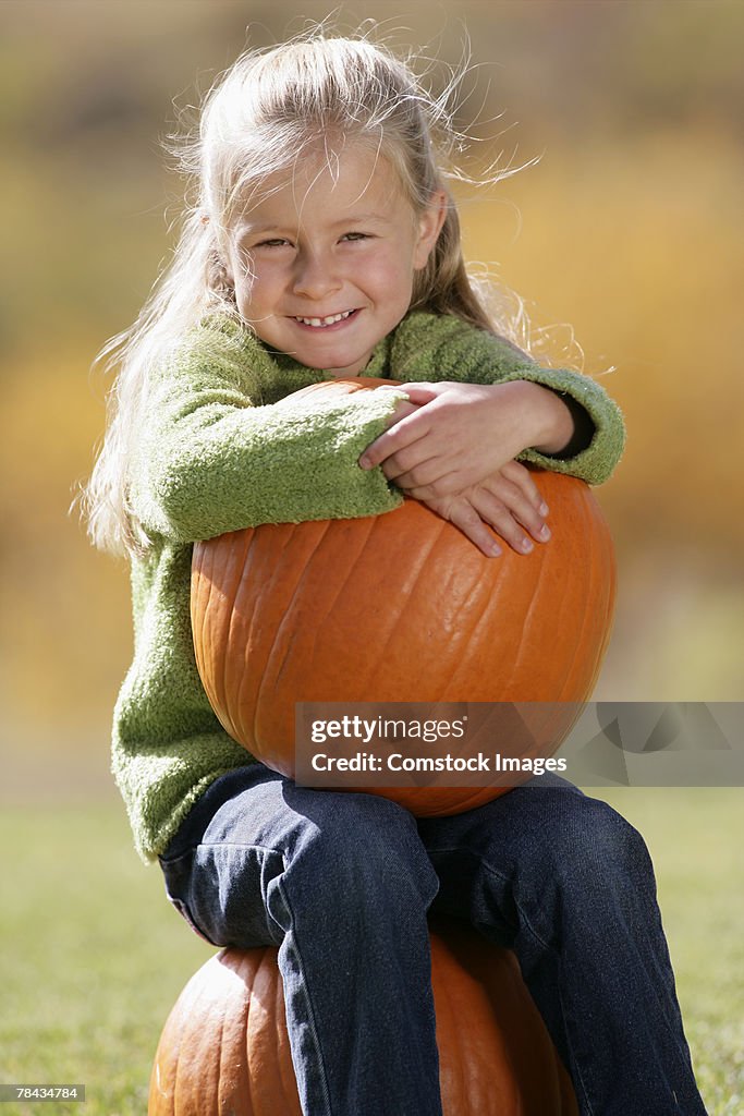 Girl holding a pumpkin