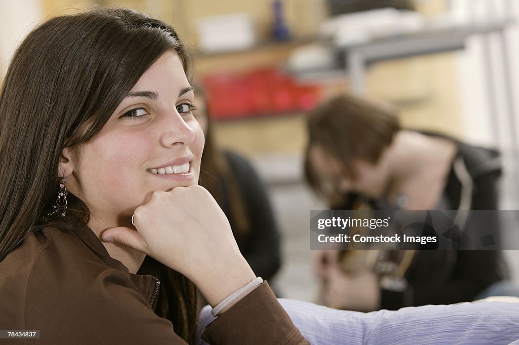Teenage girl posing with hand on chin