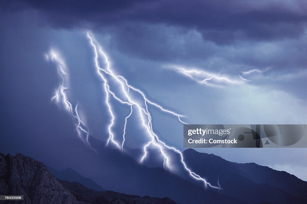 Multiple lightning bolts over landscape