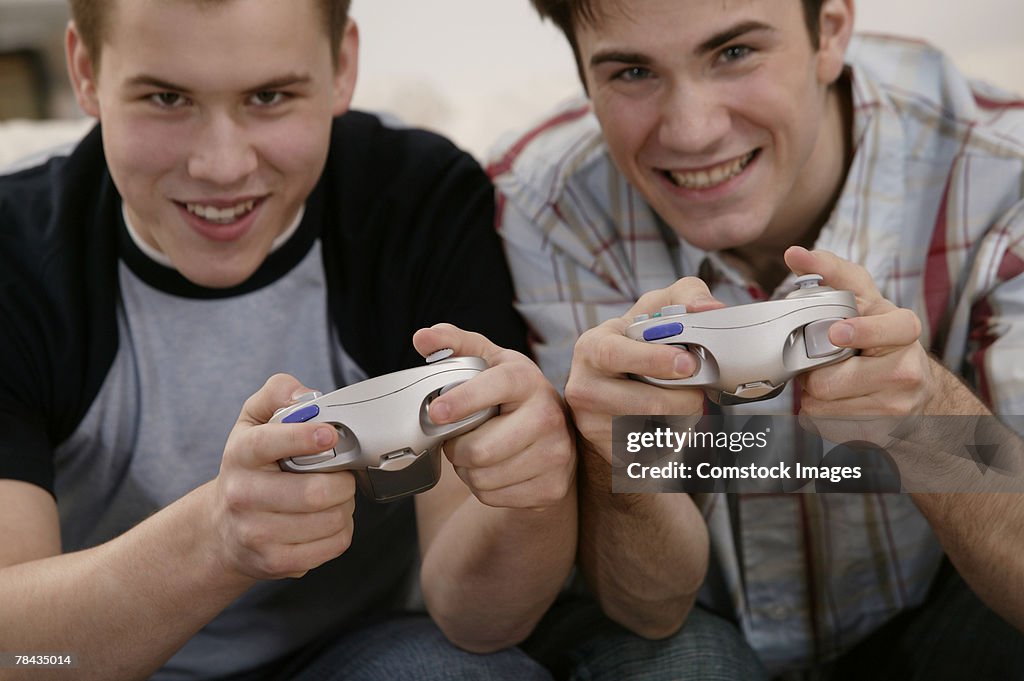 Teenage boys playing video games