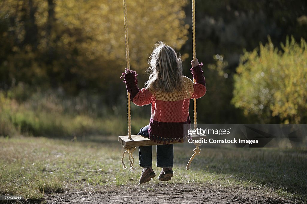 Girl sitting on a swing