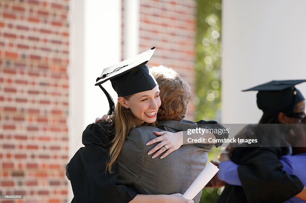 Graduate embracing parent