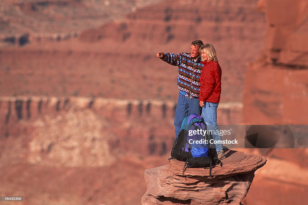 Young couple hiking at Dead-horse Point State Park , Moab , Utah