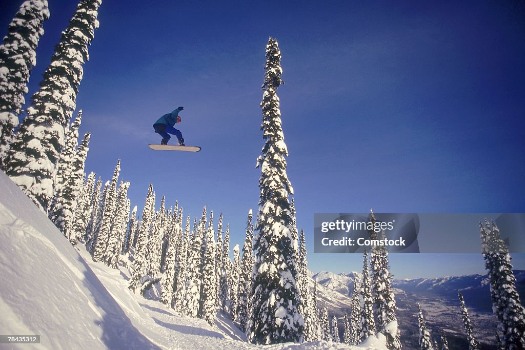 Snowboarding jumping through air , British Columbia , Canada