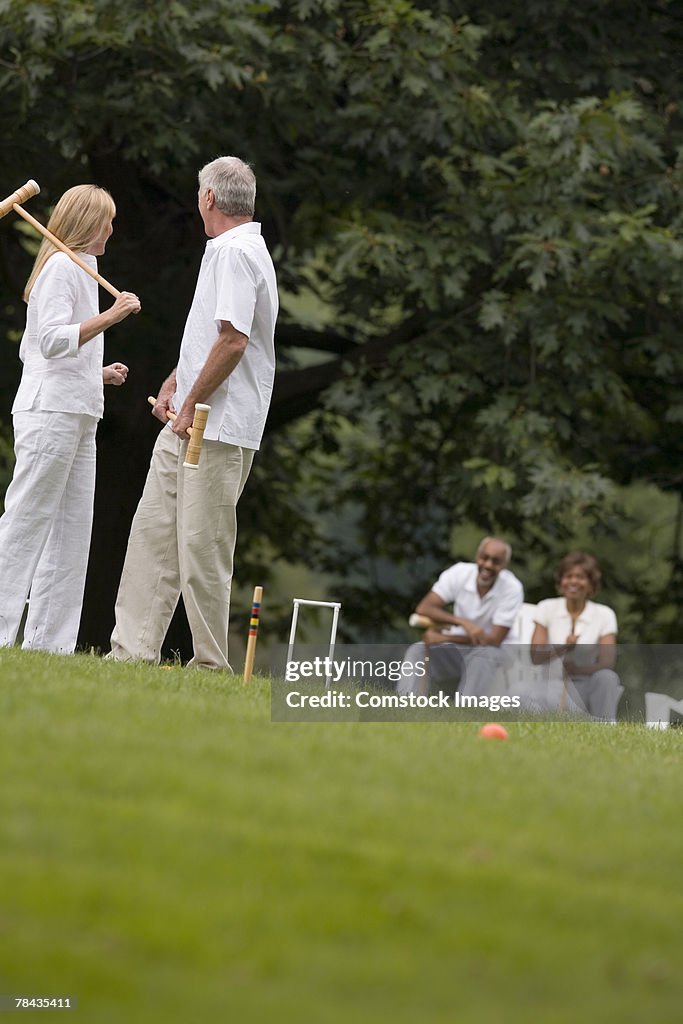 Couple playing croquet
