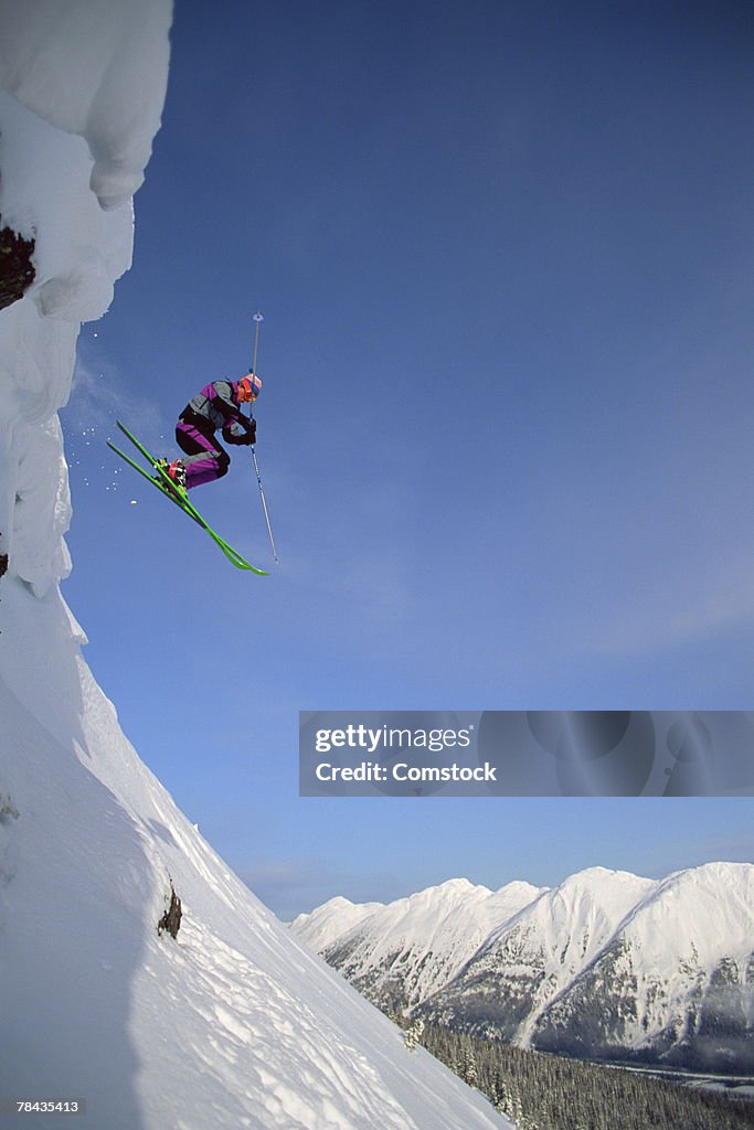 Skier going over jump , British Columbia , Canada