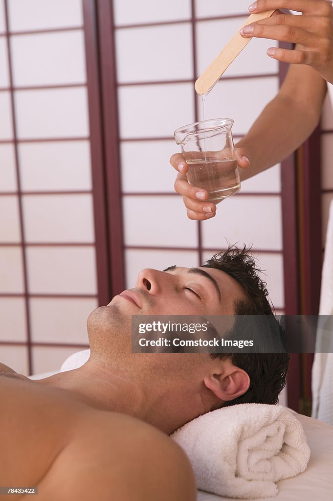 Man getting hot oil massage