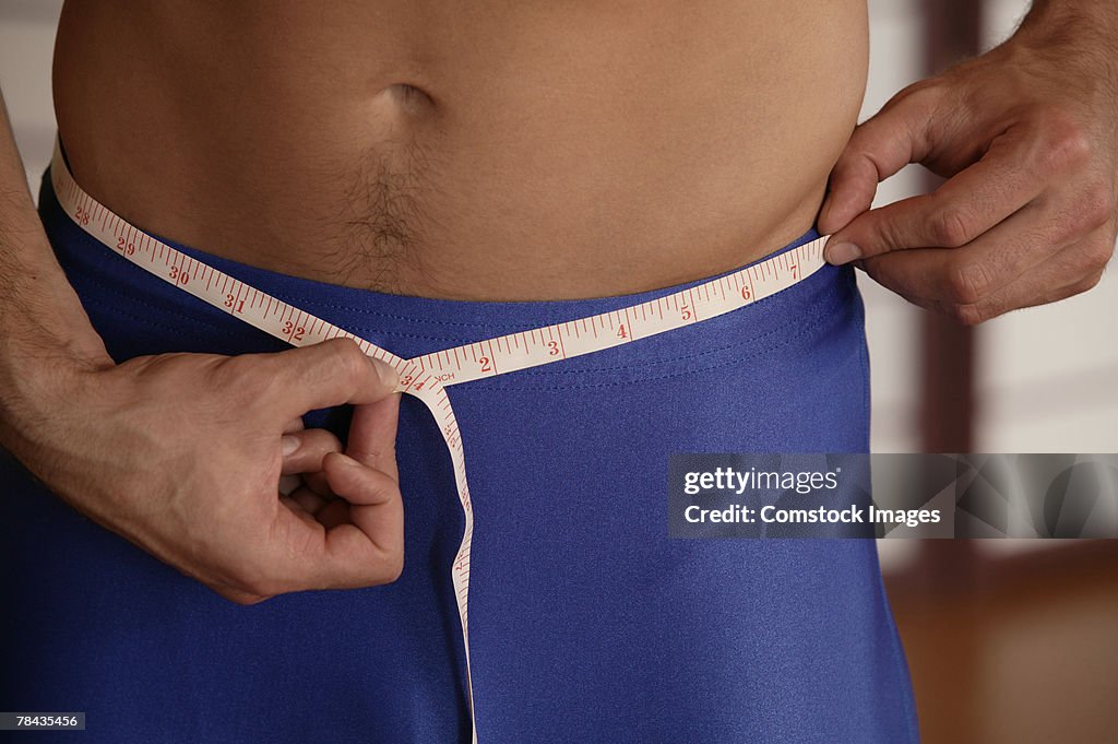 Man measuring his waist
