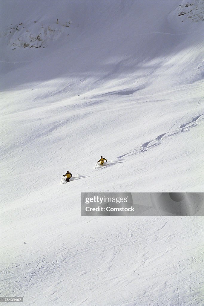 Two men powder skiing in British Columbia , Canada