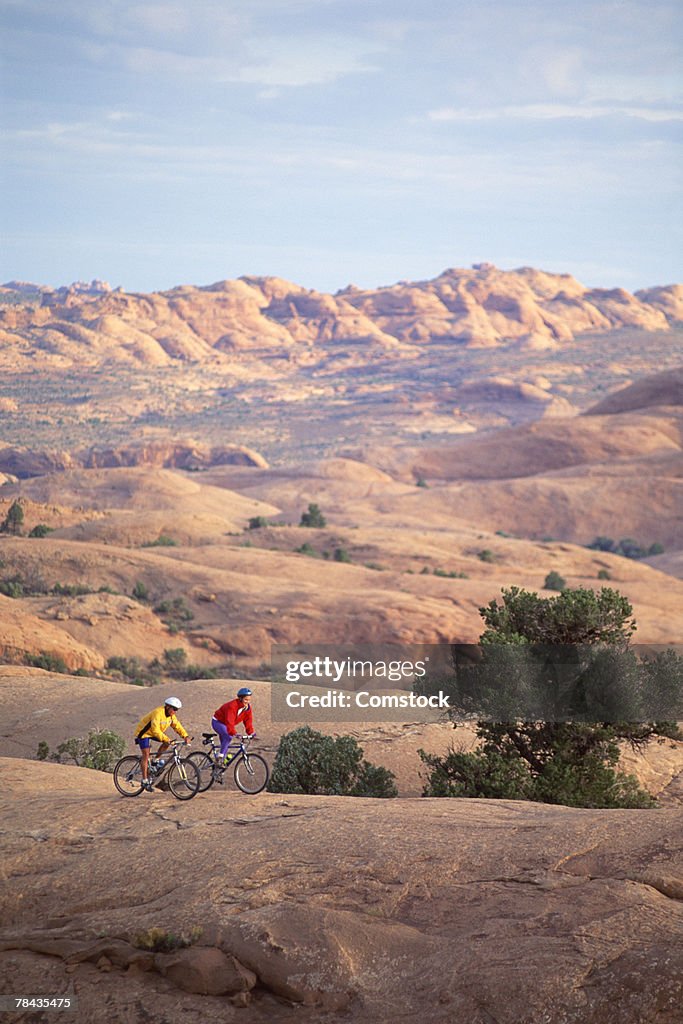 Two mountain bikers on Slickrock Trail , Moab , Utah