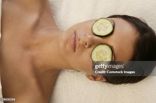 woman at spa with cucumber slices covering her eyes - hands covering eyes stock pictures, royalty-free photos & images