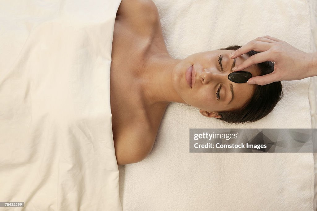 Woman getting hot stone massage