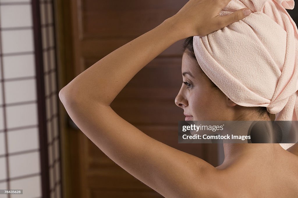 Woman with hair wrapped in towel
