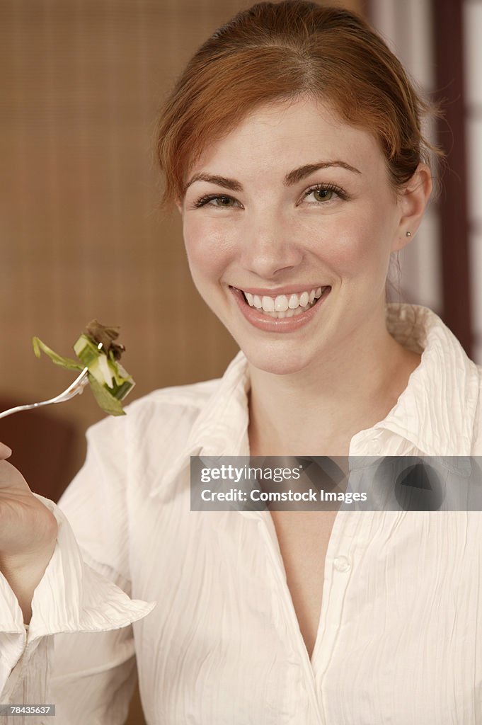 Woman eating salad