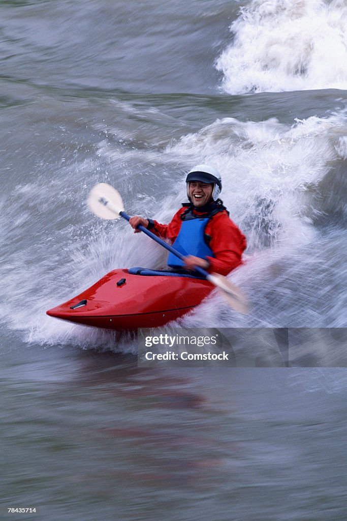 Man surfing wave in on kayak , British Columbia , Canada