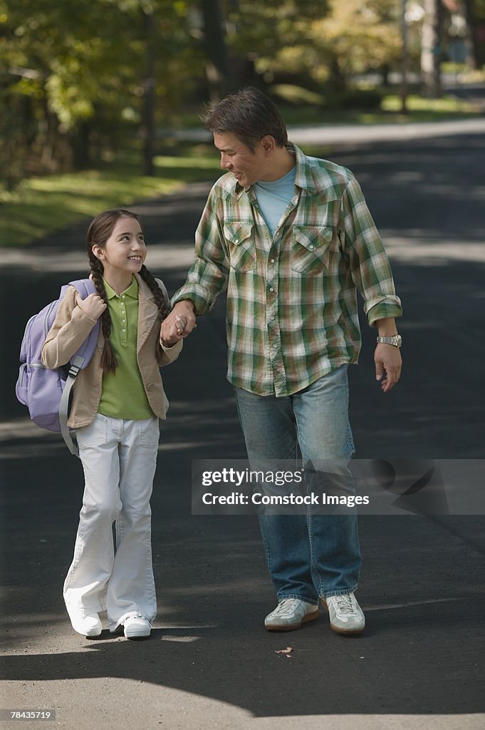 Father and daughter holding hands