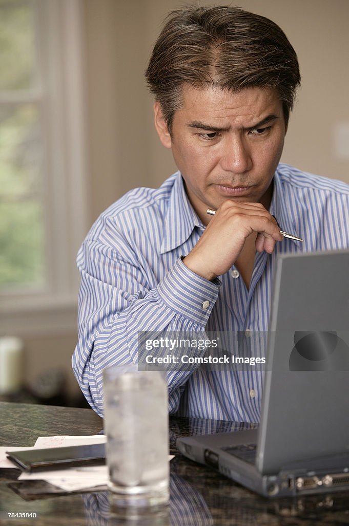 Pensive man using laptop