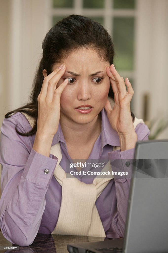 Confused woman using laptop