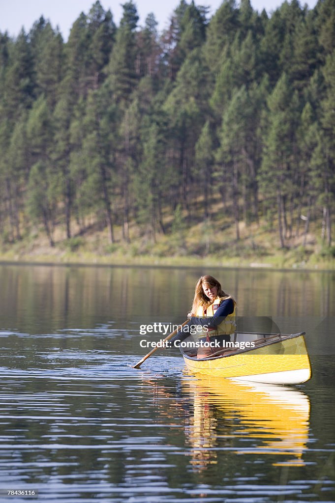 Woman paddling canoe