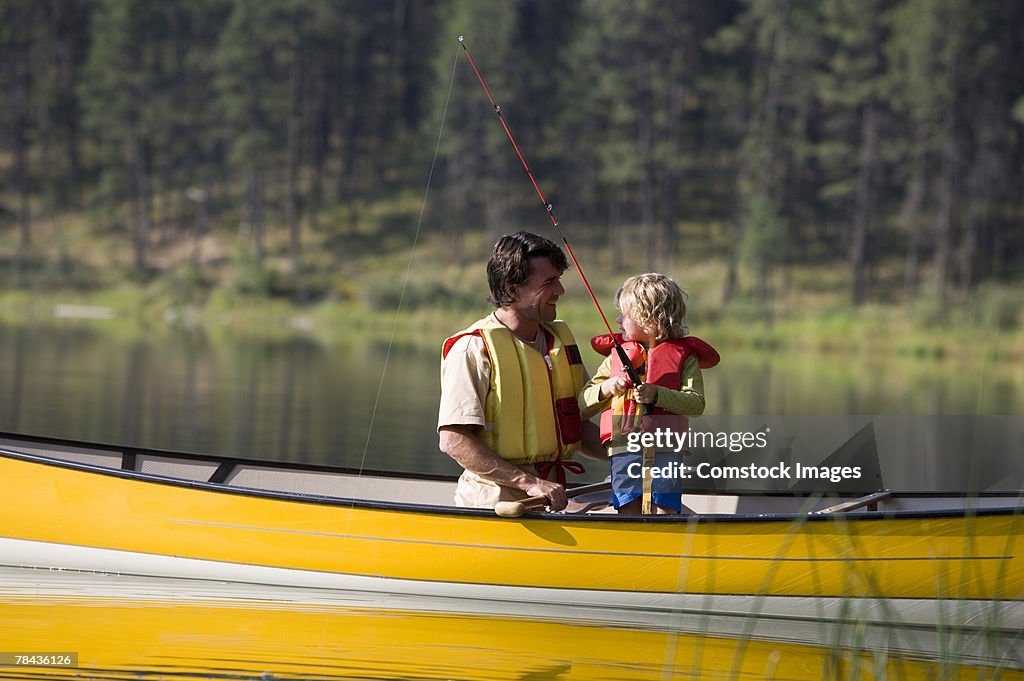 Father and child fishing in a canoe