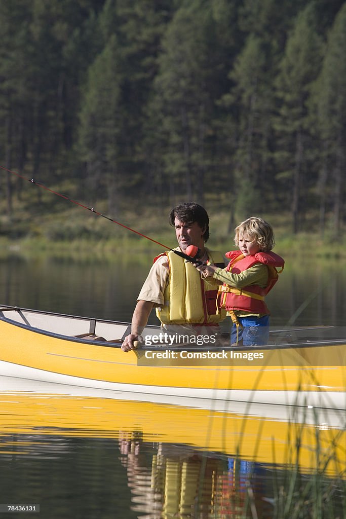 Father and child fishing in a canoe