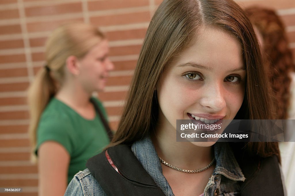 Teenage girl smiling at school