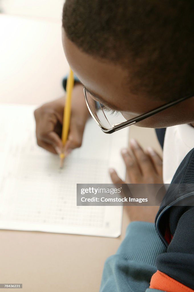 Boy writing at school