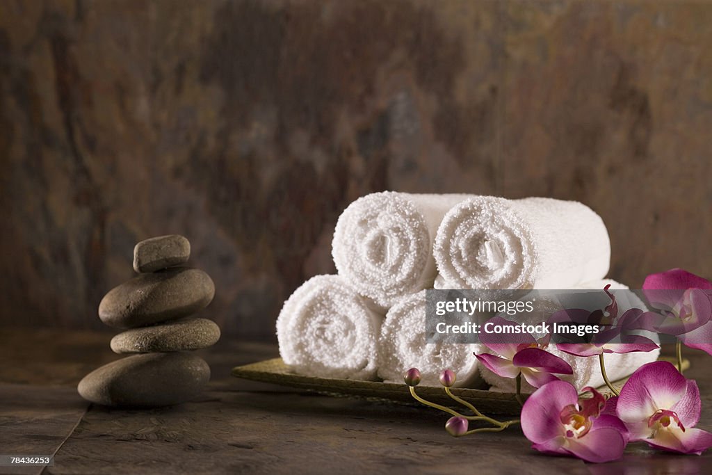 Towels, flowers, and stones