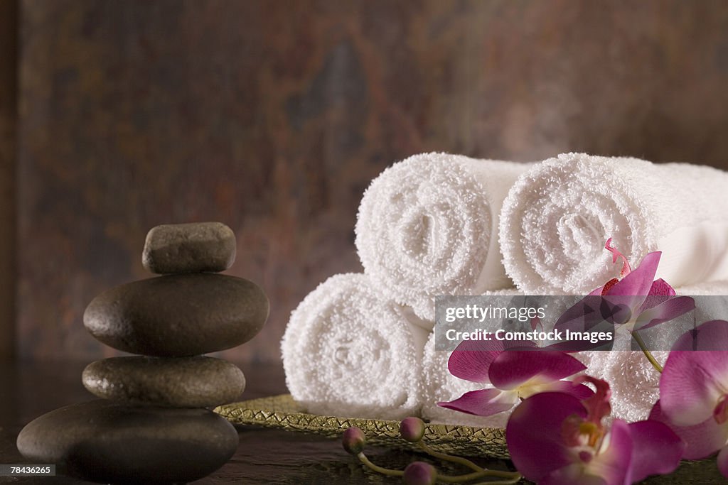 Towels, flowers, and stones