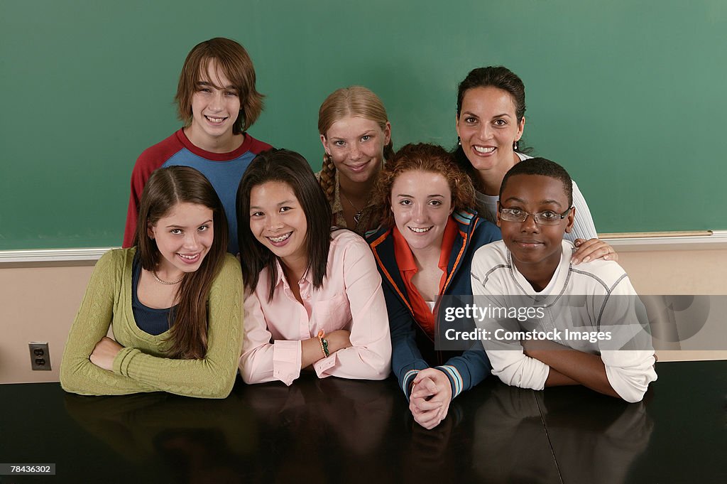 Group of teenagers with teacher at school