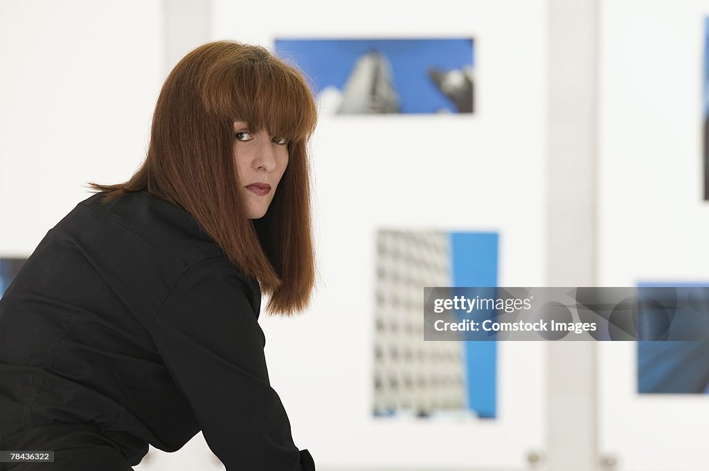 Photographer with hanging artwork