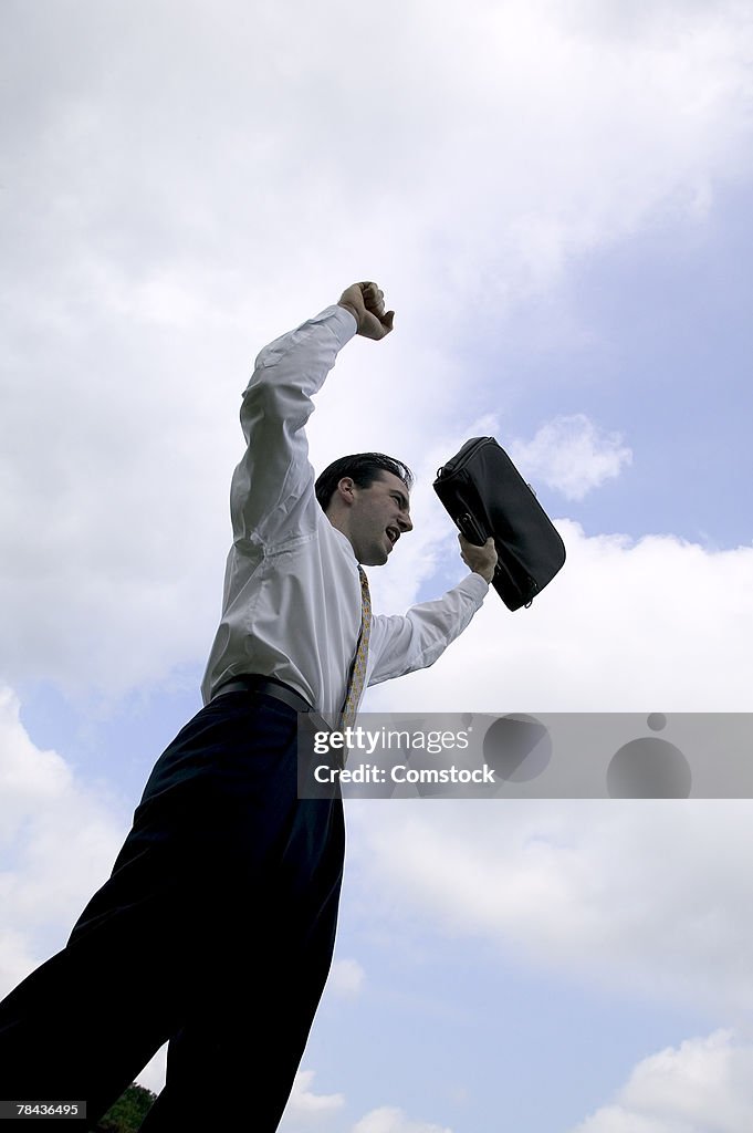 Businessman with arms raised in the air