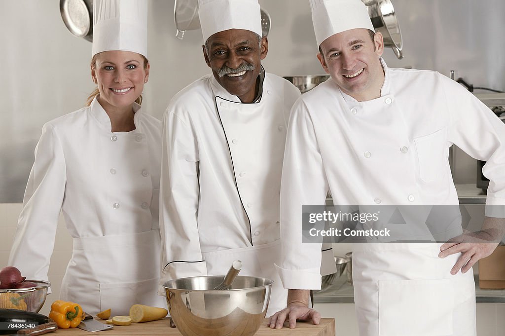 Chefs posing in kitchen