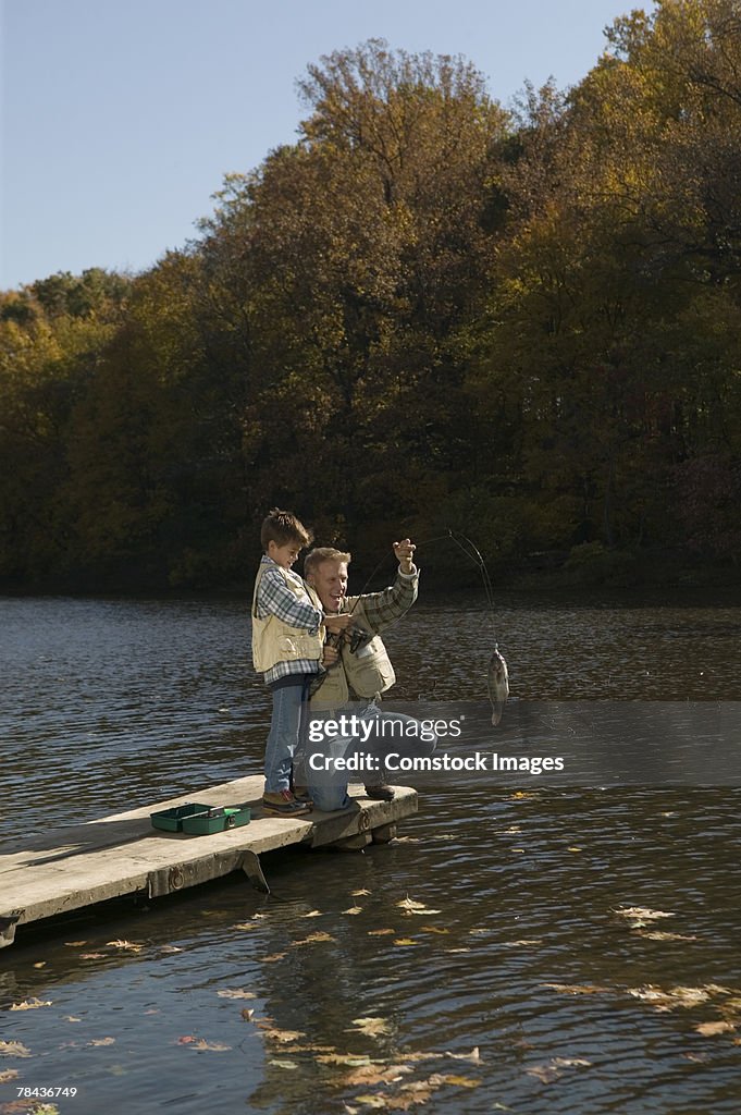 Father and son catching a fish