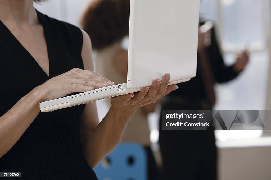 Woman holding laptop computer