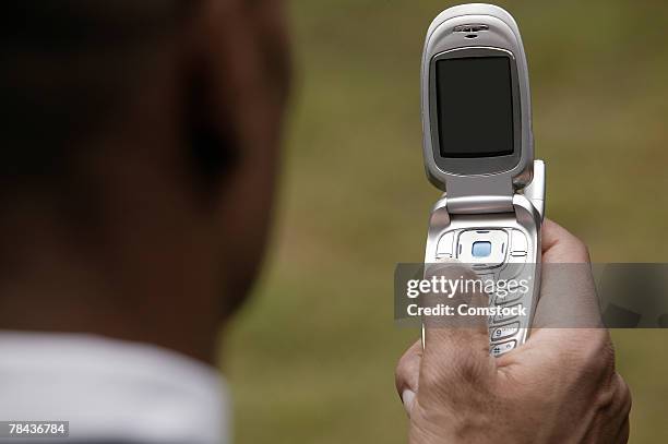 man using cell phone - feature phone stockfoto's en -beelden