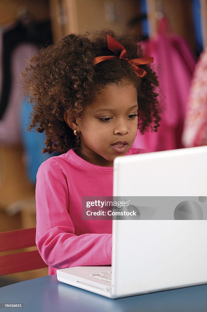 Young girl using laptop