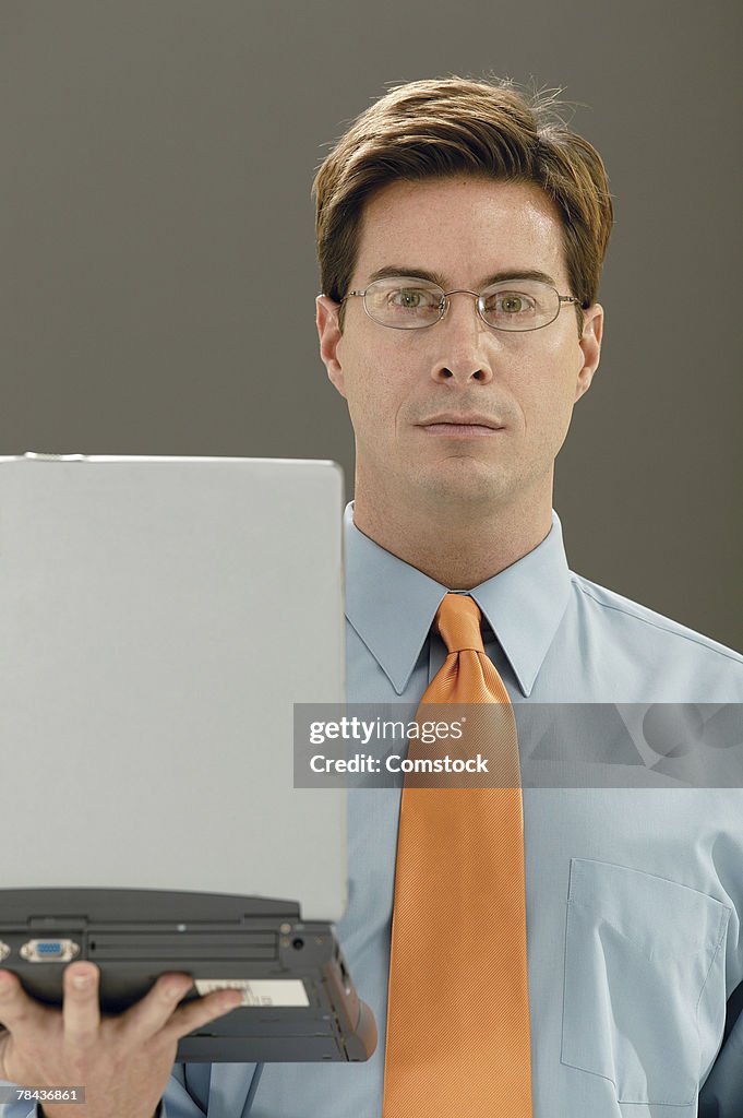 Businessman holding laptop computer