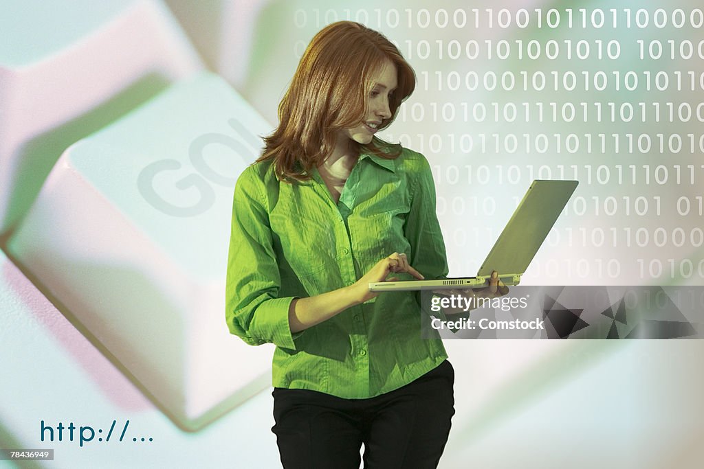 Woman holding laptop computer with binary code and go button