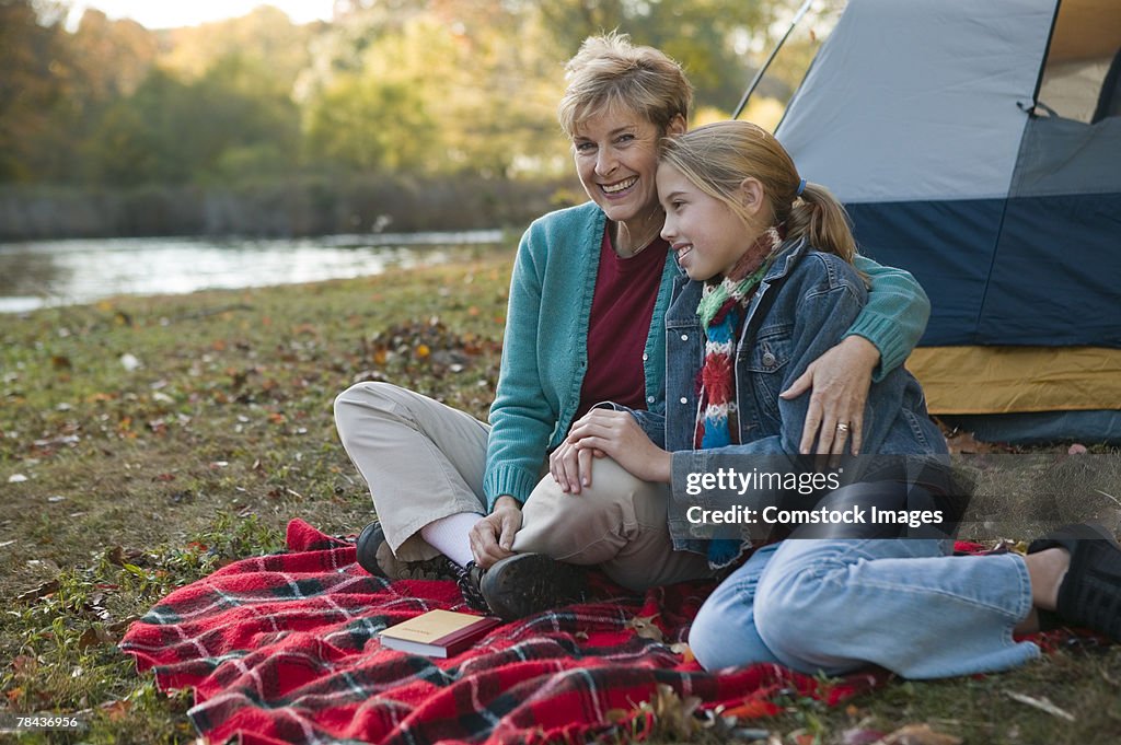 Grandmother and granddaughter camping