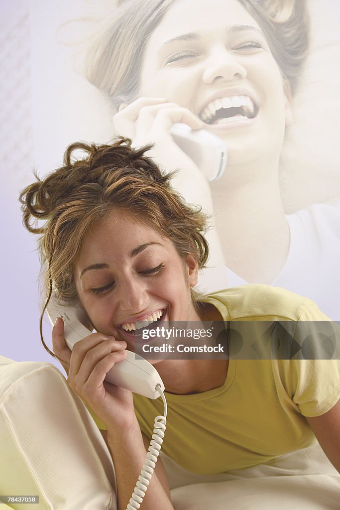 Teenage girl talking on telephones