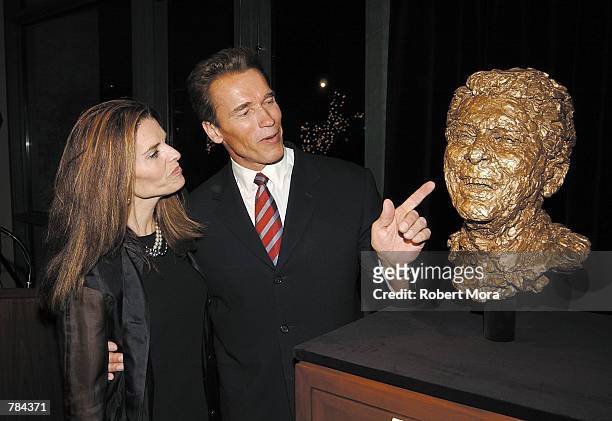 Actor Arnold Schwarzenegger and his wife Maria Shriver admire the bronze sculpted Ronald Reagan bust created by artist Robert Berks, at the Ronald...