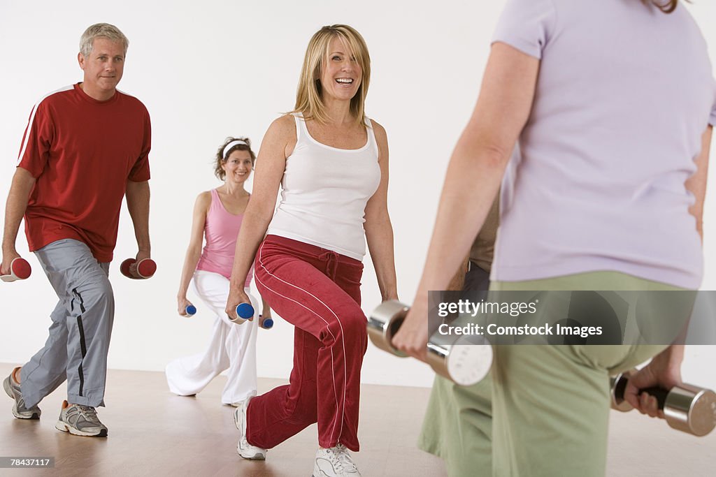 Exercise class working out with free weights