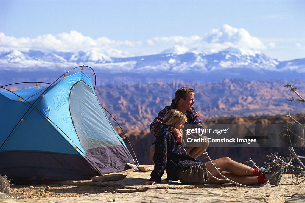 Couple camping by canyon landscape