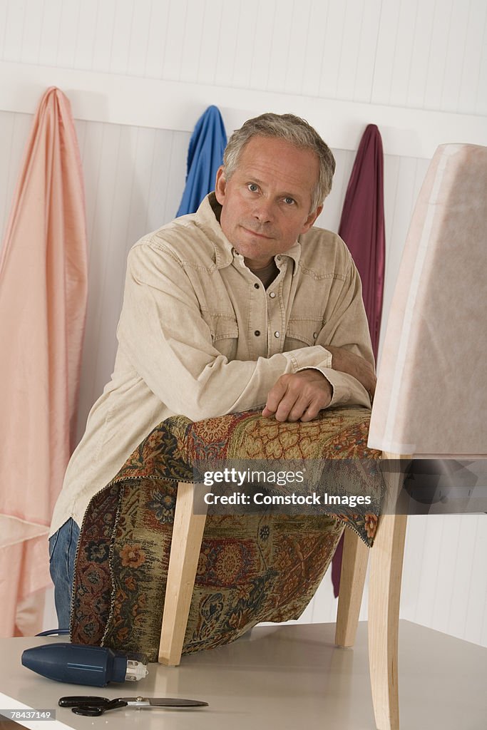 Man upholstering a chair